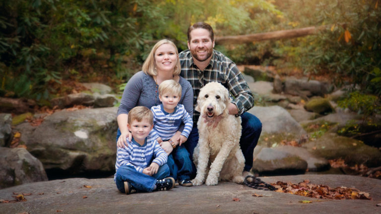 Dr. Simpson and her husband and two children and dog in wooded scene